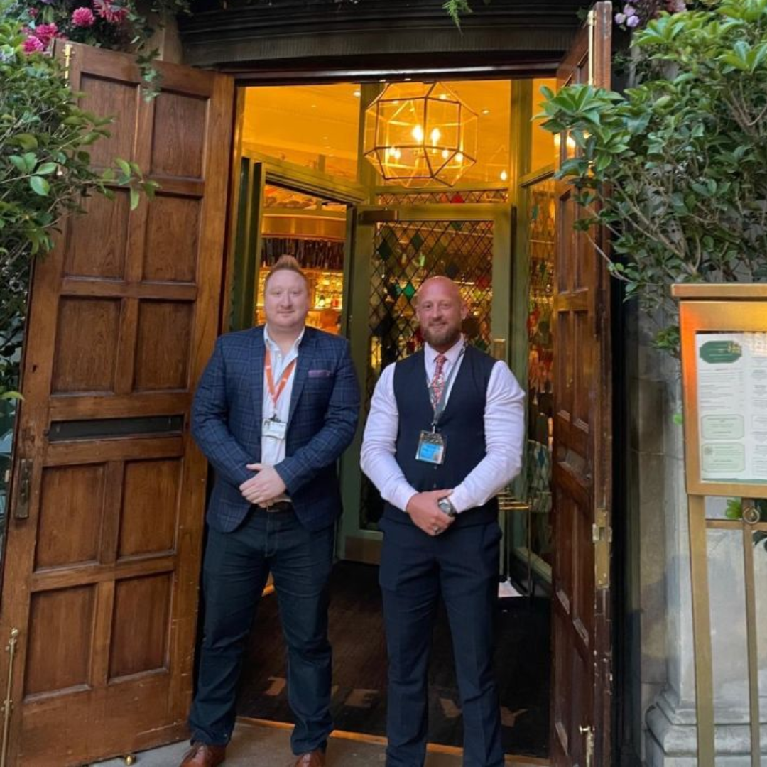 2 door supervisors stood in front of a door