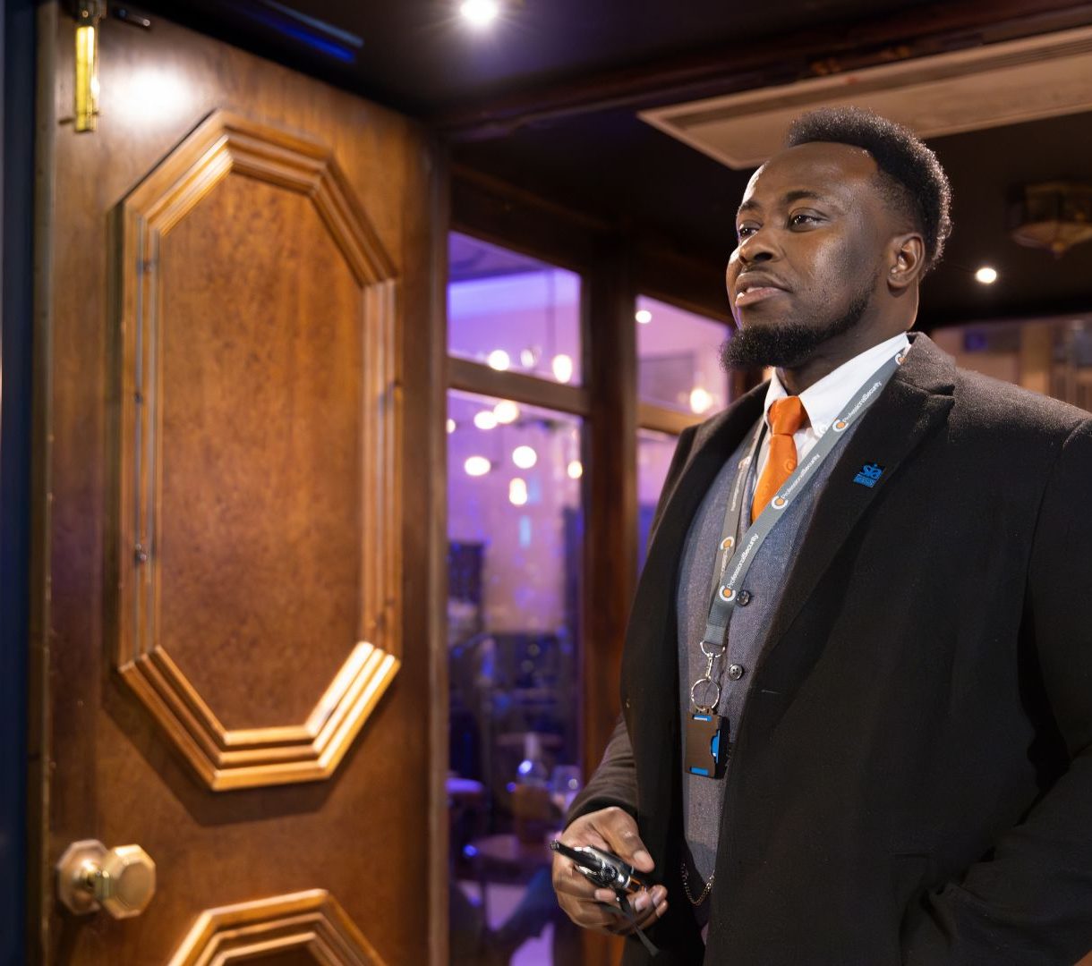 Member of staff stood on the door of a venue